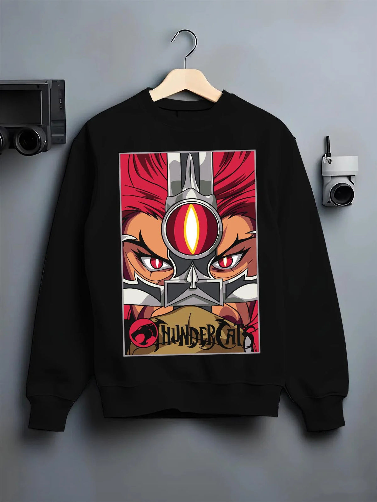Black crewneck sweatshirt on hanger featuring Thundercats Eye of Thundera artwork.