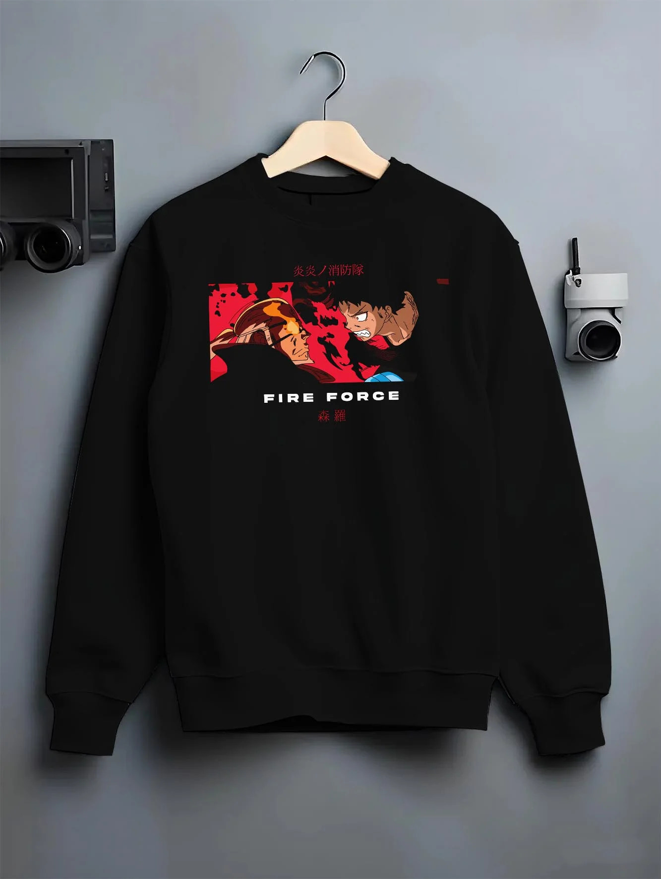 Black crewneck sweatshirt on hanger with Fire Force Hoodie Shinra Kusakabe Burning Kick Pose graphic premium wear.