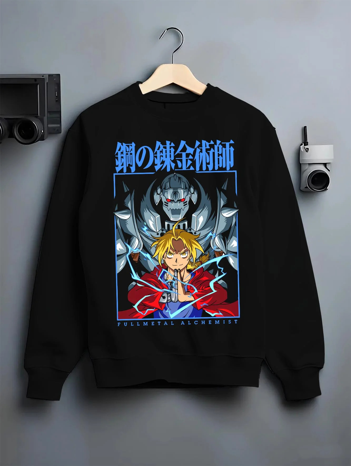Black crewneck sweatshirt on hanger with Edward Elric Hoodie Fullmetal Alchemist Anime Panel graphic bold anime graphic.