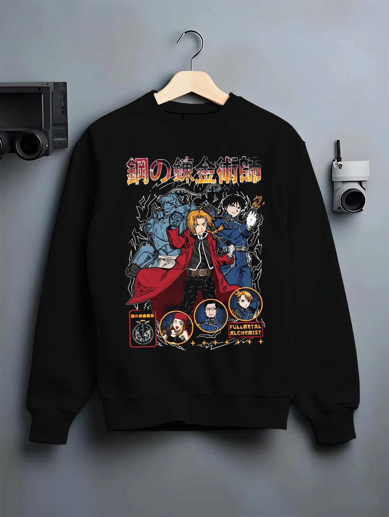 Black crewneck sweatshirt on hanger with Fullmetal Alchemist Hoodie Brotherhood Retro Design graphic streetwear graphic.