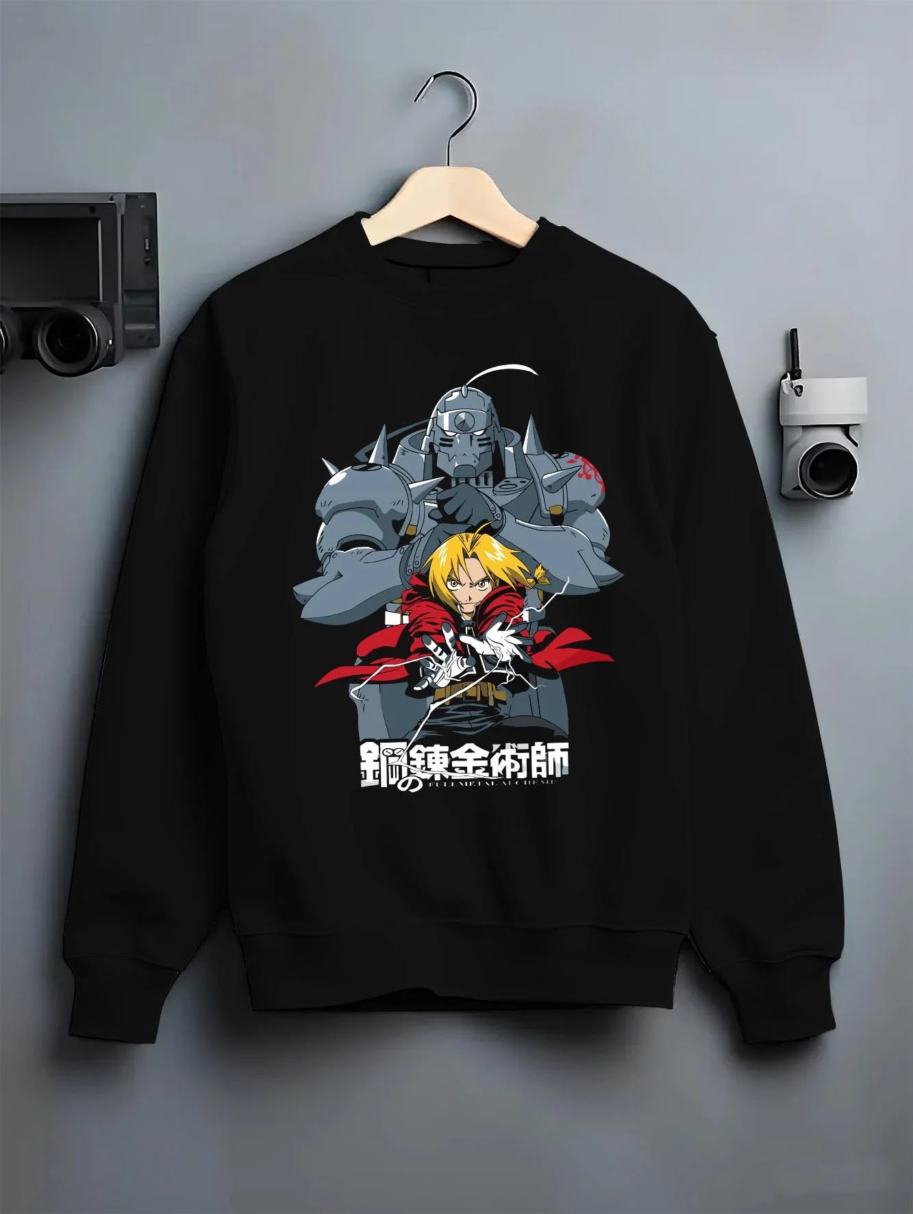 Black crewneck sweatshirt on hanger with Edward Elric Hoodie Fullmetal Alchemist Silver Armor graphic bold anime graphic.