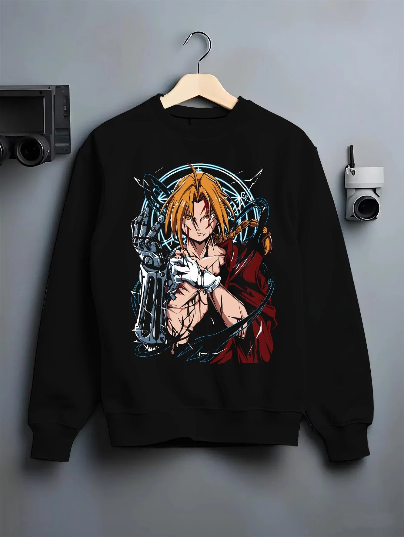 Black crewneck sweatshirt on hanger with Edward Elric Hoodie Fullmetal Alchemist Metal Arm graphic bold anime graphic.