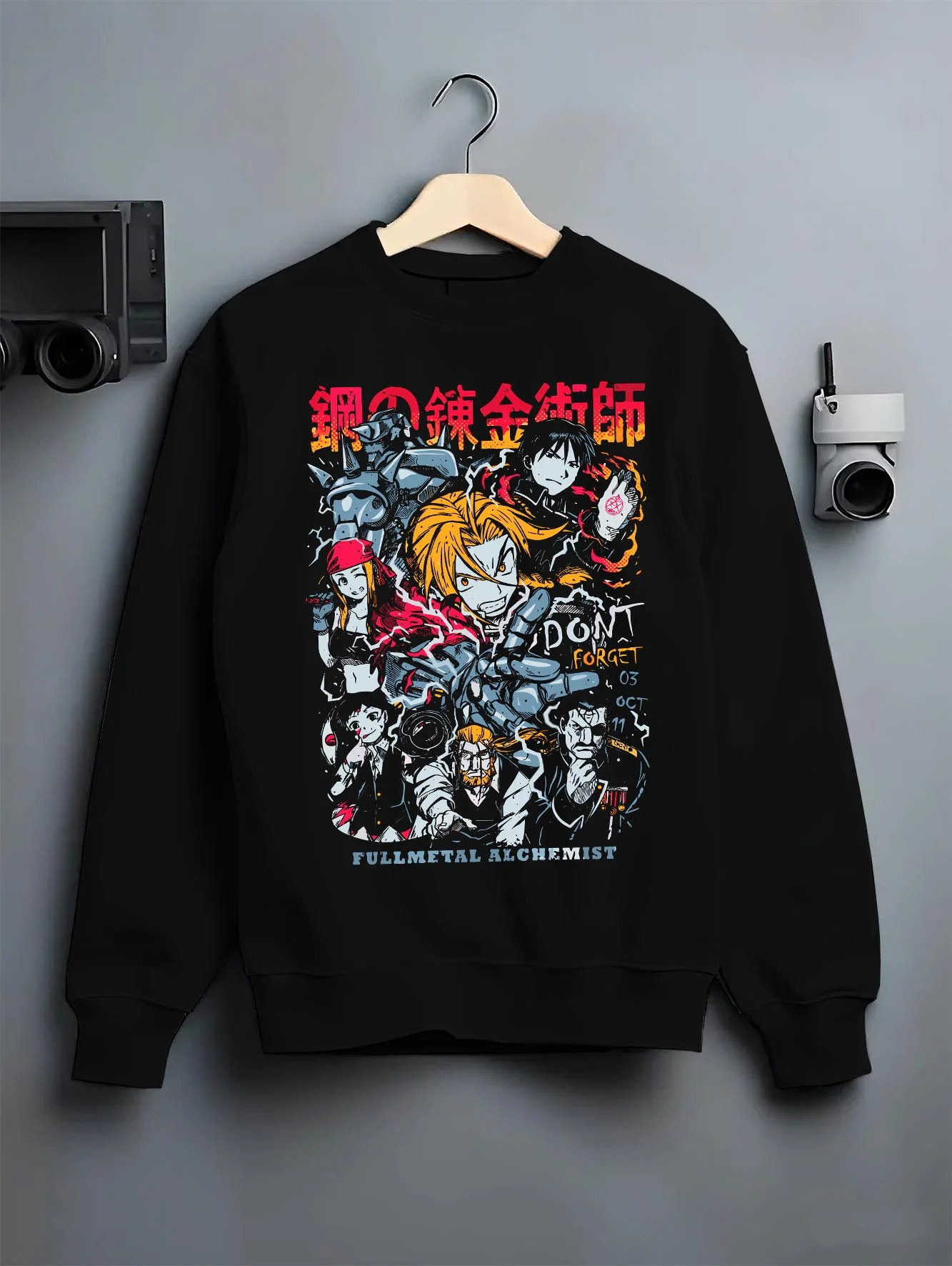 Black crewneck sweatshirt on hanger with Edward Elric Hoodie Fullmetal Alchemist Don’t Forget graphic streetwear graphic.