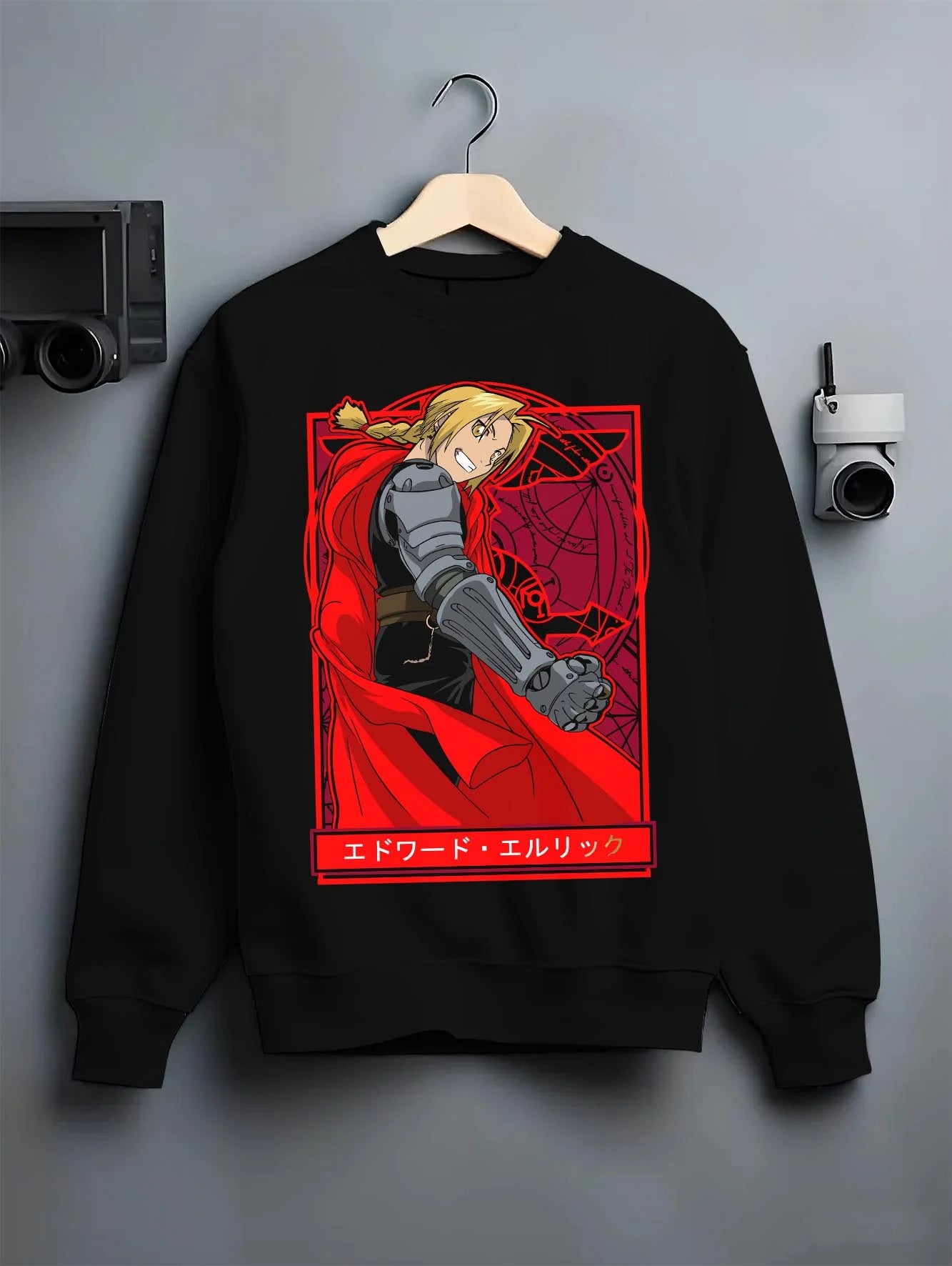 Black crewneck sweatshirt on hanger with Edward Elric Hoodie Fullmetal Alchemist Red Cape graphic bold anime graphic.