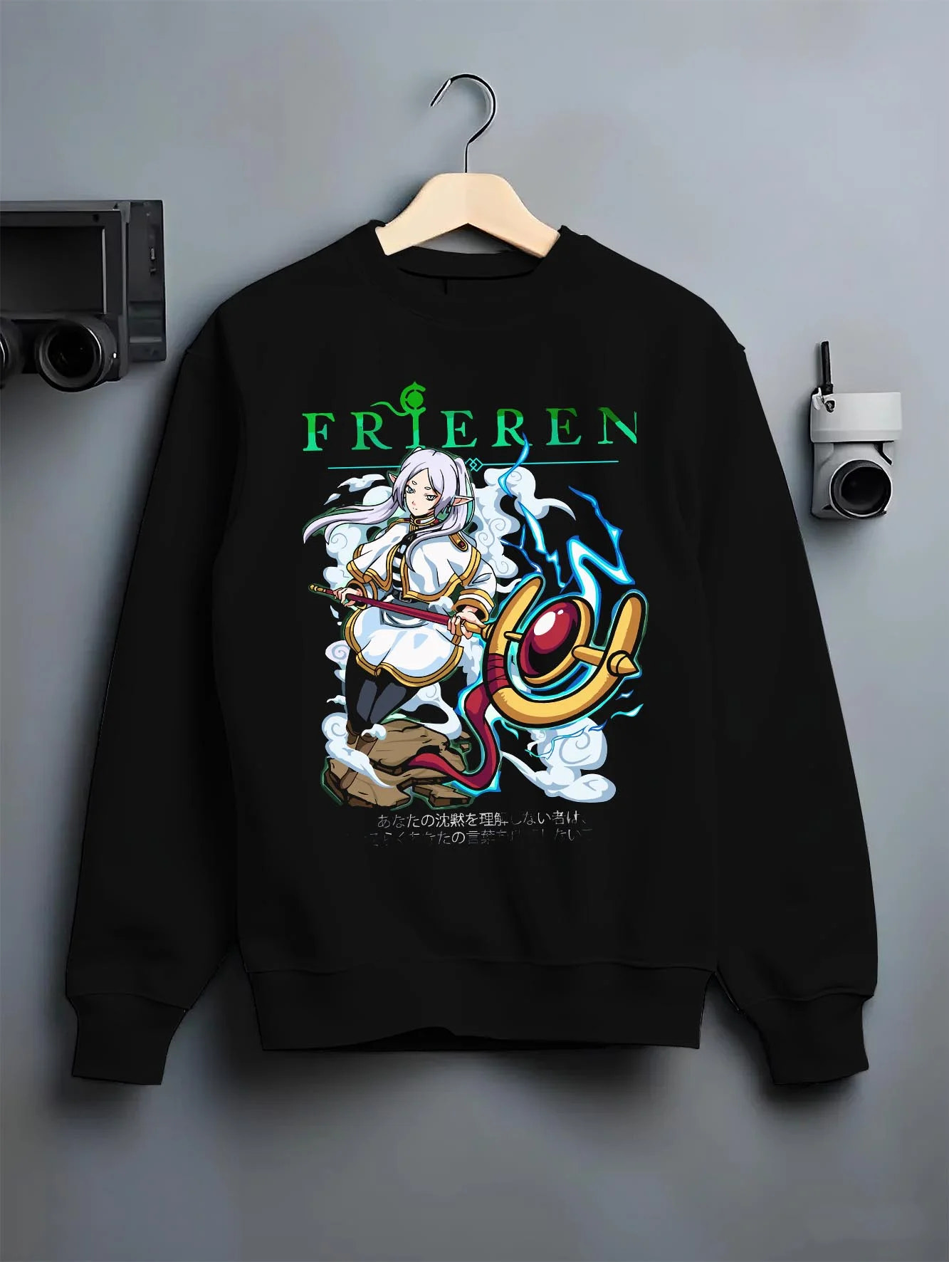 Black crewneck sweatshirt on hanger with Frieren Hoodie Beyond Journey’s End Magic Pose graphic streetwear graphic.