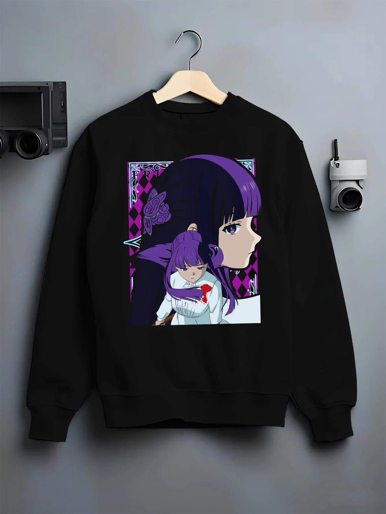 Black crewneck sweatshirt on hanger with Frieren Hoodie Beyond Journey’s End Purple Dress graphic bold anime graphic.