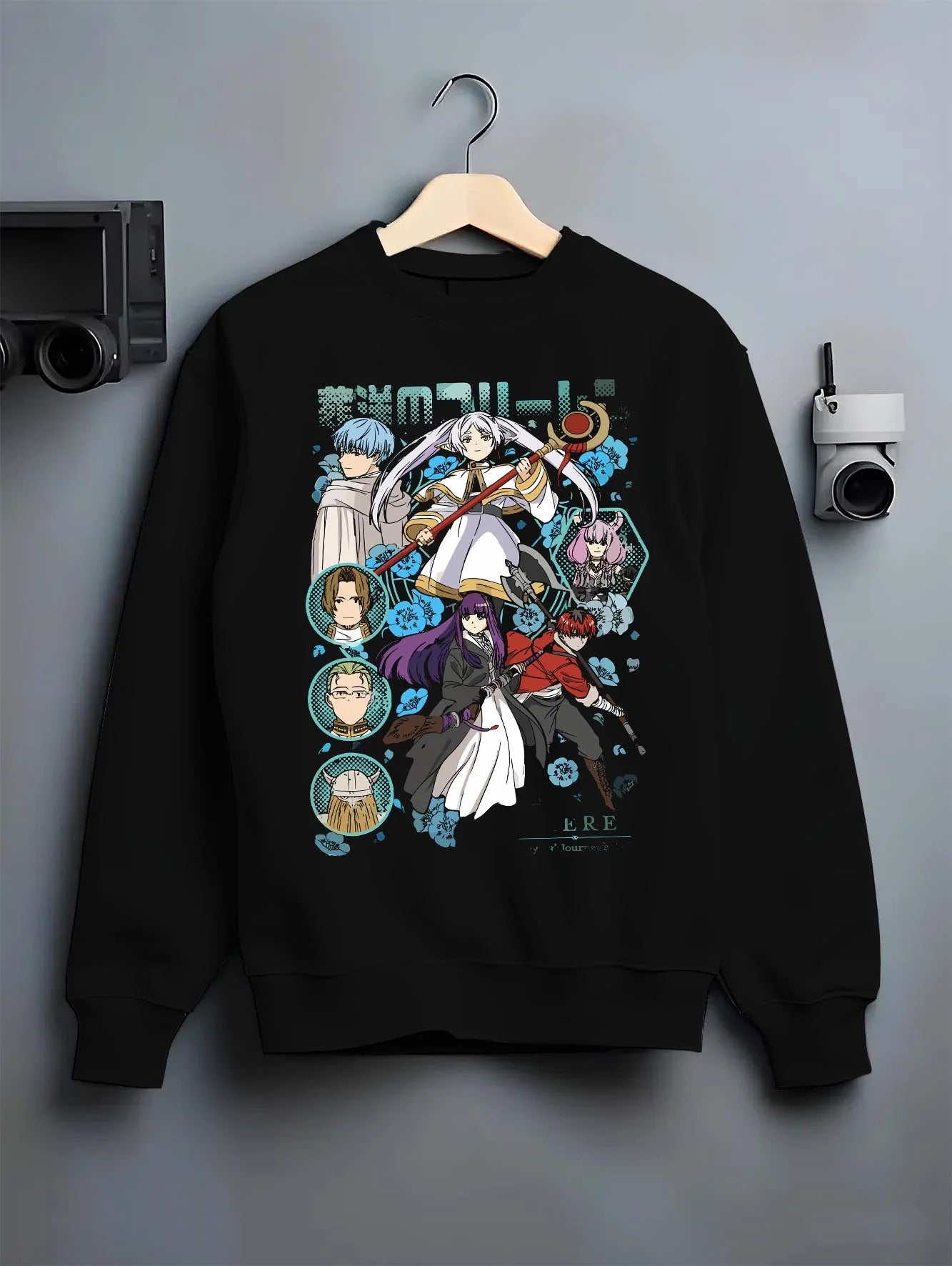 Black crewneck sweatshirt on hanger with Frieren Hoodie Beyond Journey’s End Adventure Cast graphic premium wear.