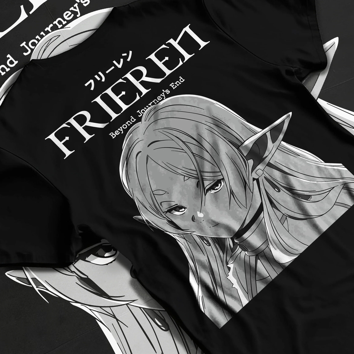 Black T-shirt flat back view showing Frieren from Frieren: Beyond Journey's End: monochrome portrait