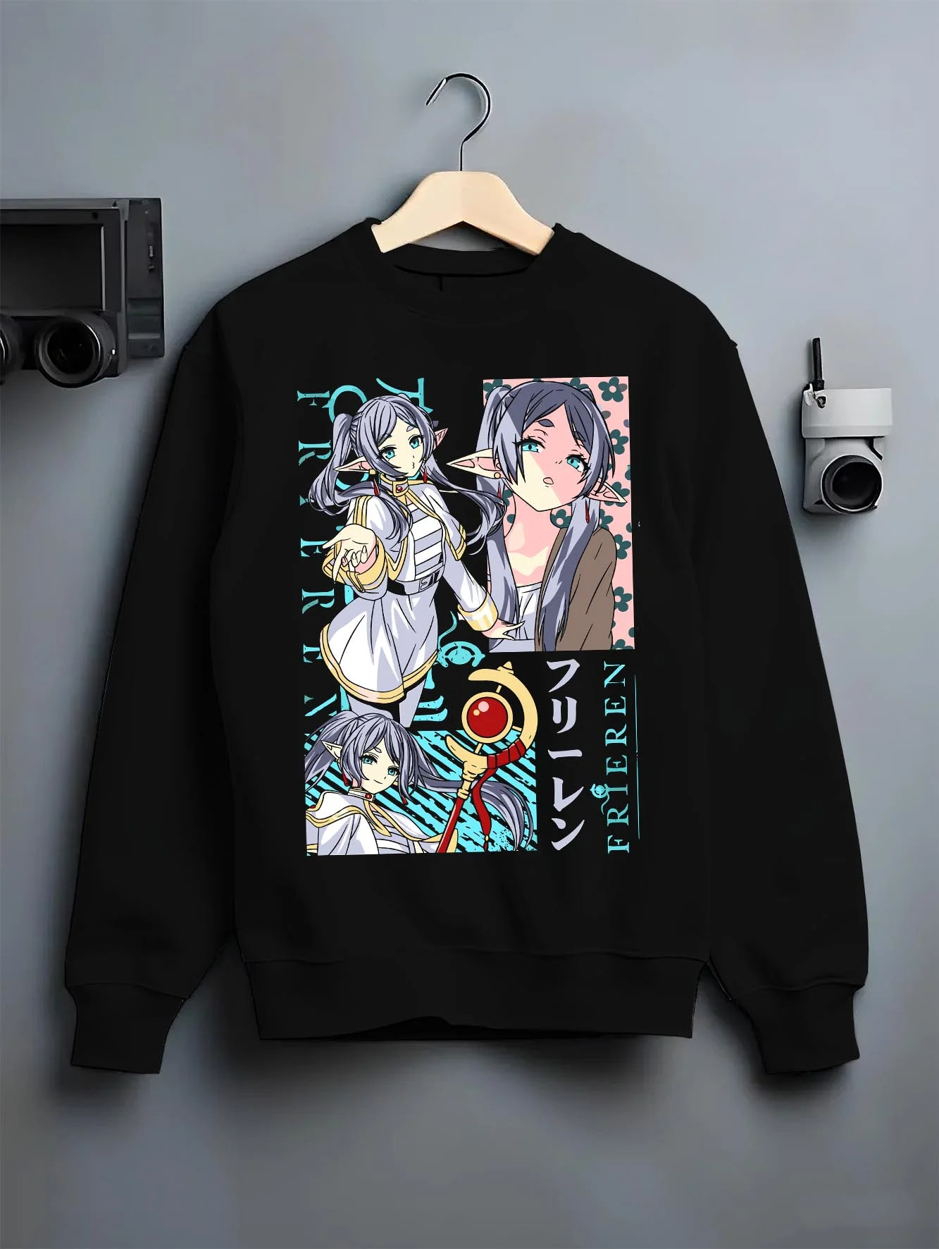Black crewneck sweatshirt on hanger with Frieren Hoodie Beyond Journey’s End Twin Sisters graphic premium wear.