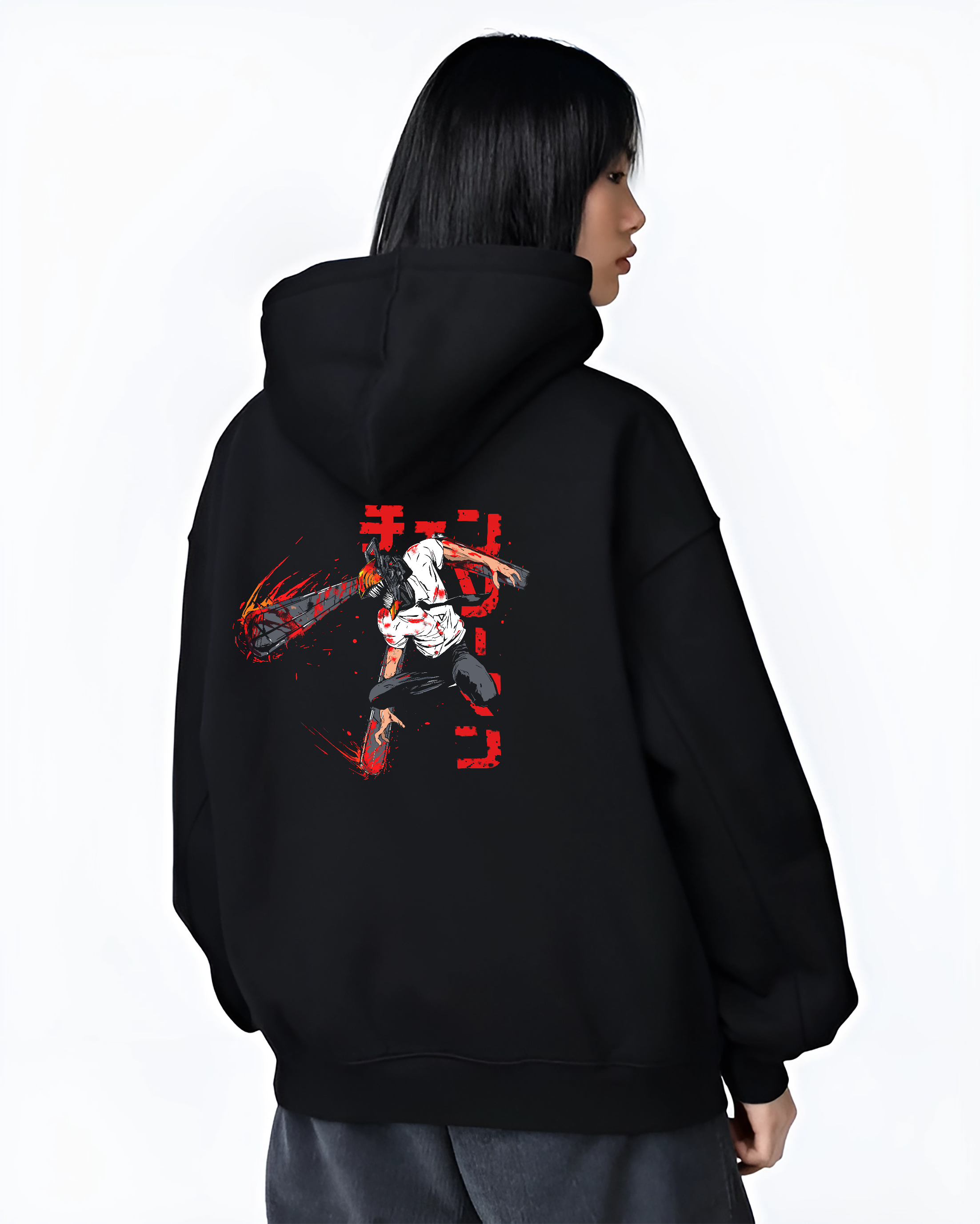 Black hoodie worn by a female model, back view, featuring Chainsaw Man Denji anime poster inspired artwork print with shonen battle character design and Japanese streetwear style.