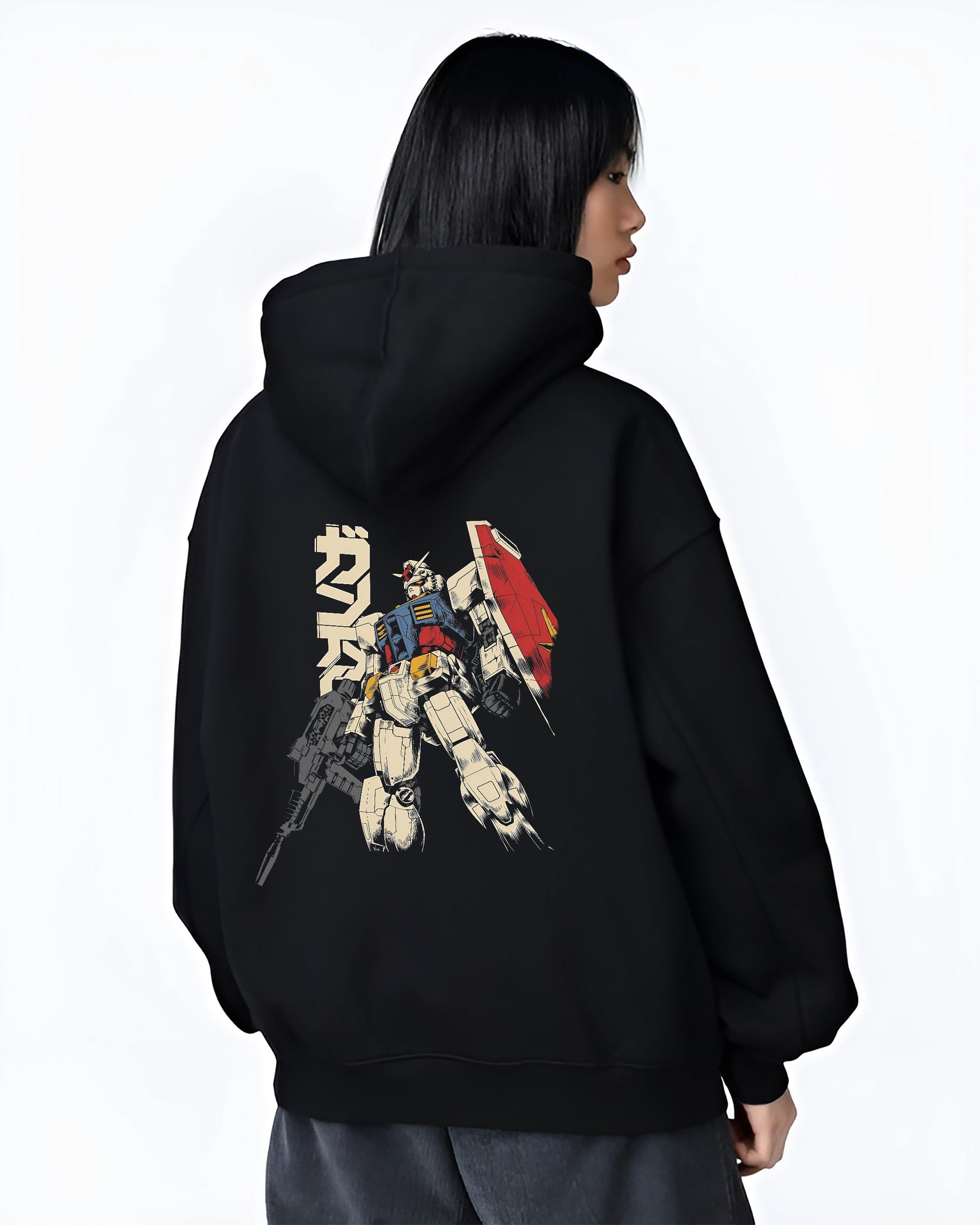 Black hoodie worn by a female model, back view, featuring Mobile Suit Gundam retro manga graphic artwork with Japanese animation inspired mecha streetwear design.