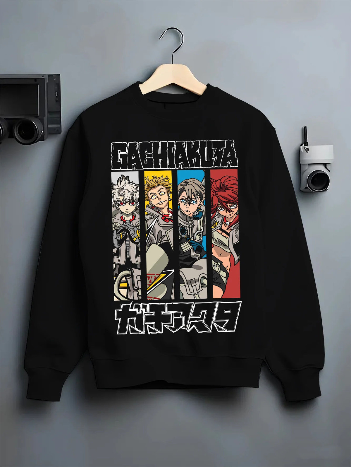 Black crewneck sweatshirt on hanger showing Gachiakuta: Rudo and ensemble character panels