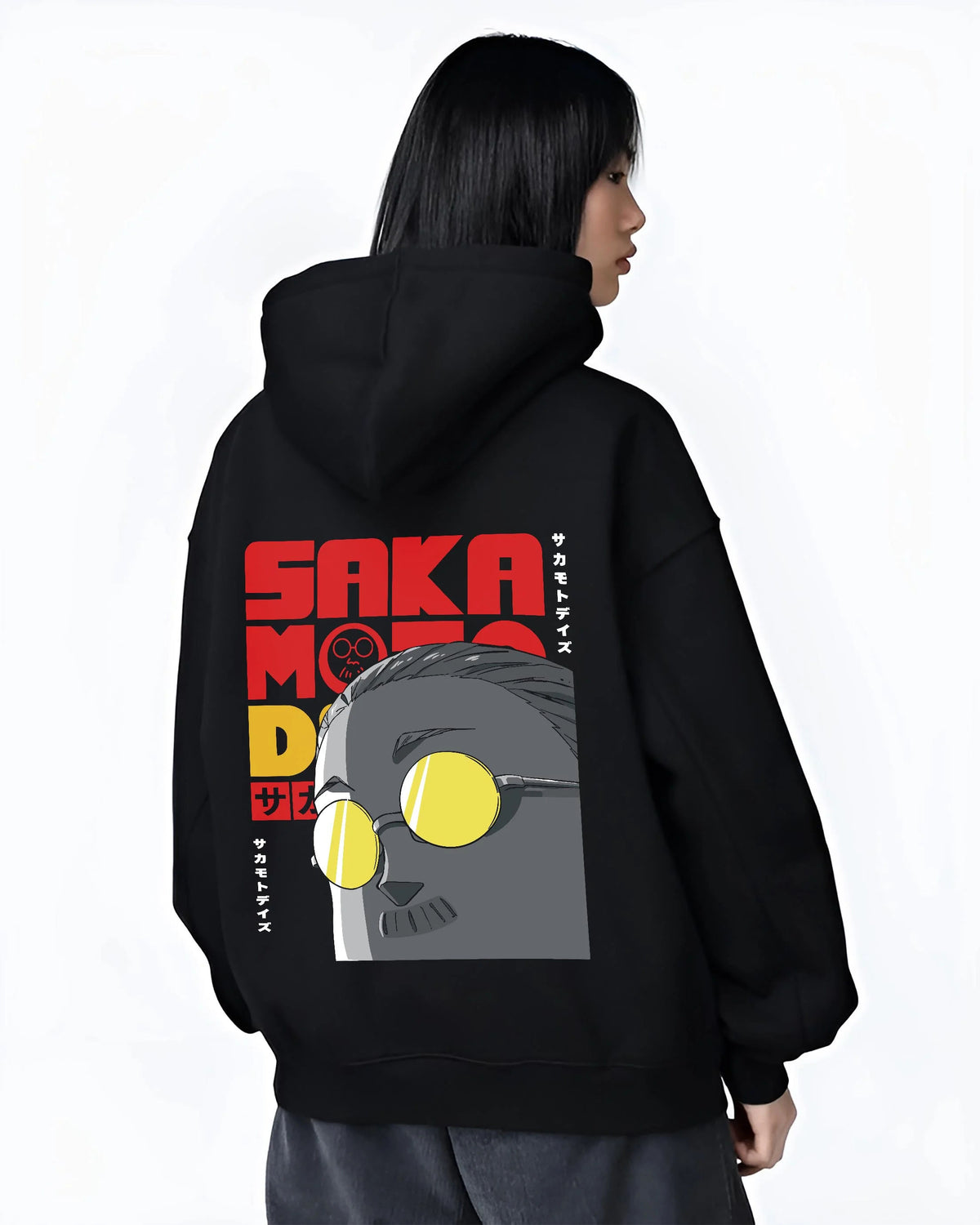 Black hoodie worn by female model from the back featuring Sakamoto Days gas mask assassin artwork.