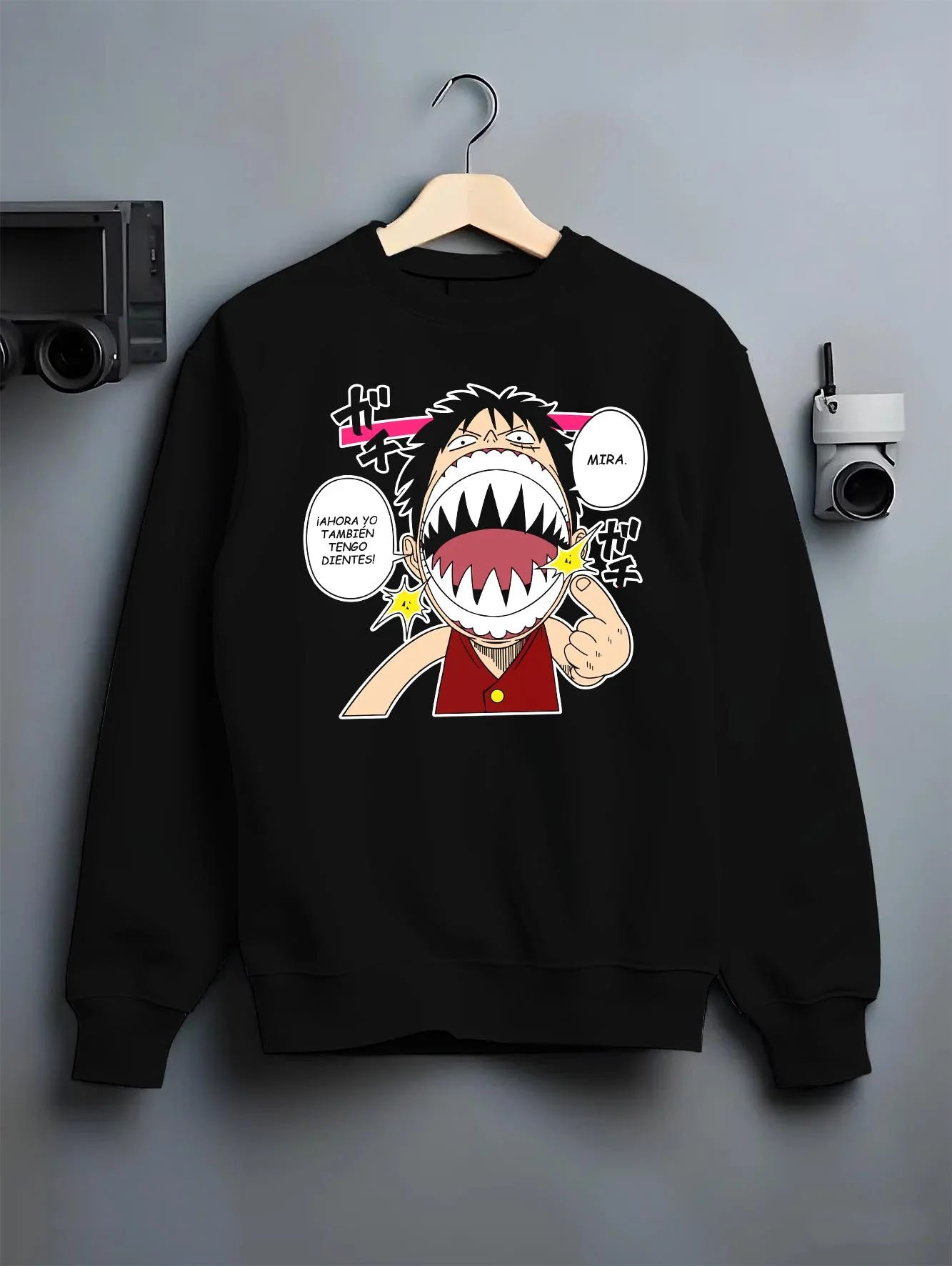 Black crewneck sweatshirt on hanger with One Piece Hoodie Luffy Funny Shark Mouth Jumper graphic premium wear.