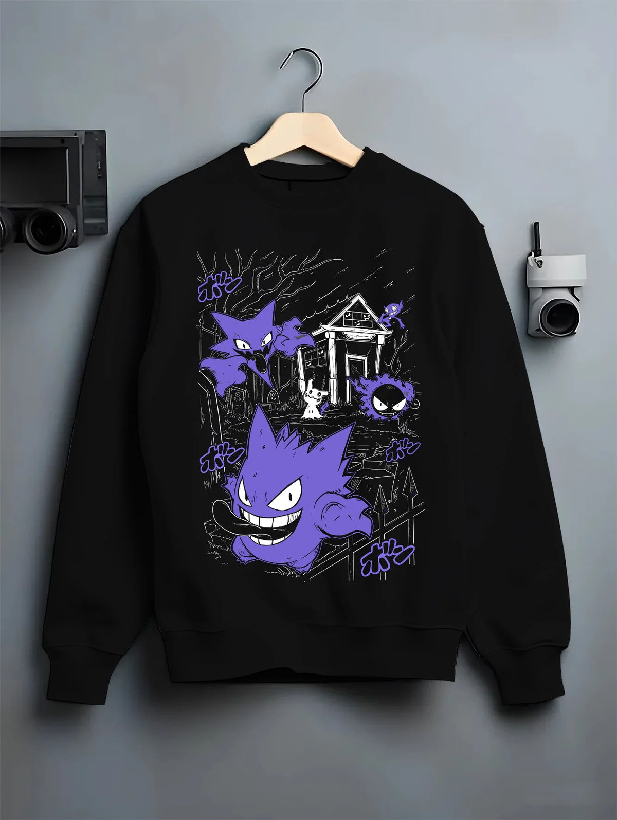 Black crewneck sweatshirt on hanger with Gengar Haunted House collage from Pokémon illustrated back graphic