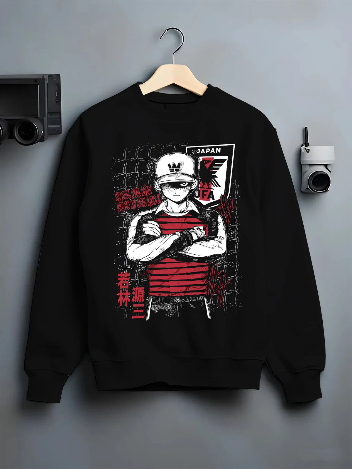 Black crewneck sweatshirt on hanger showing Genzo Wakabayashi from Captain Tsubasa: Japan national goalkeeper