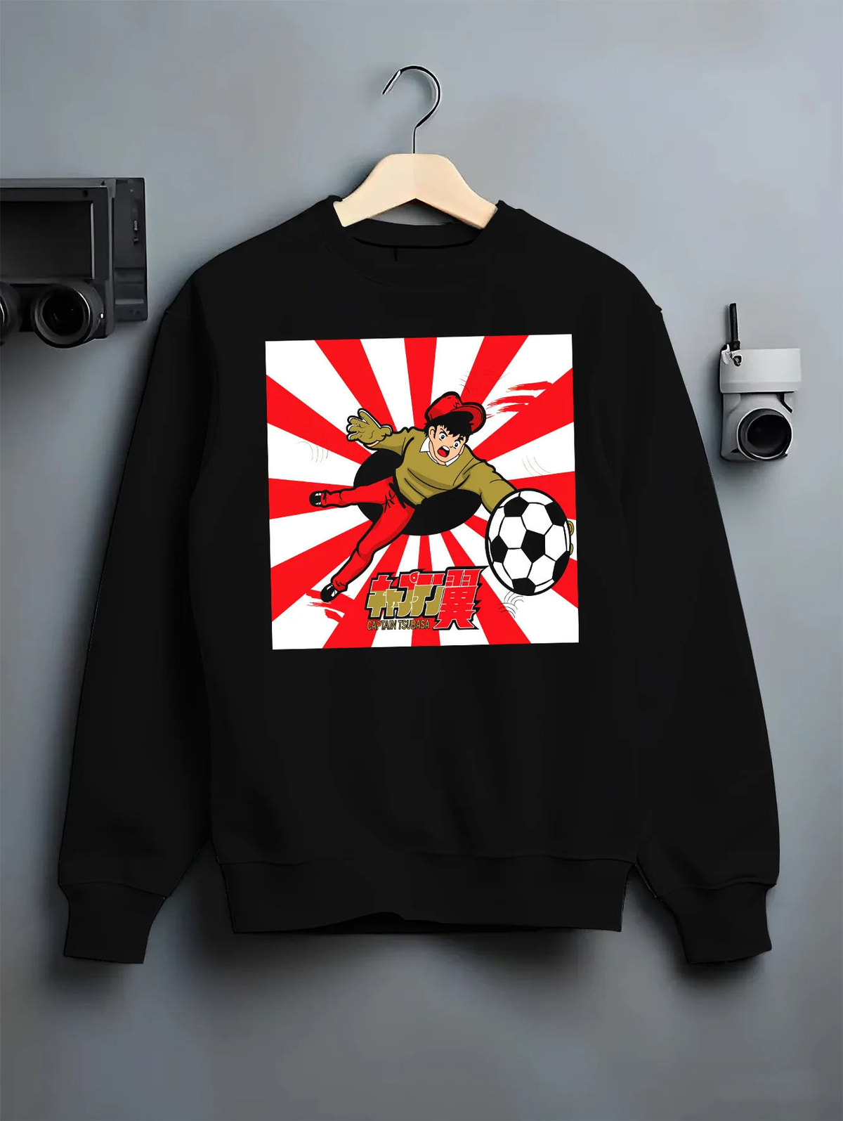 Black crewneck sweatshirt on hanger with Genzo Wakabayashi soccer goalkeeper from Captain Tsubasa illustrated back graphic