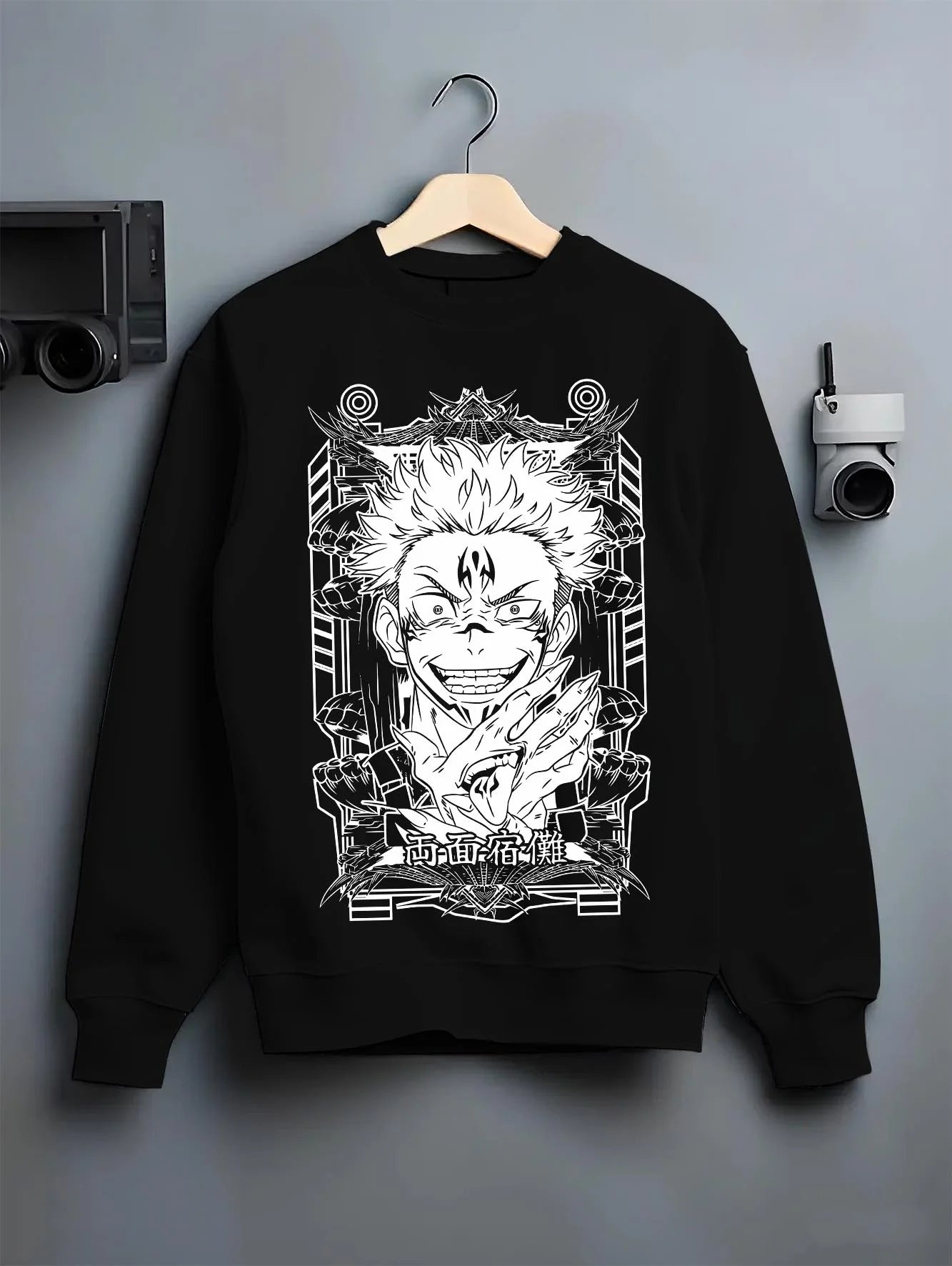 Black crewneck sweatshirt on hanger with Jujutsu Kaisen Hoodie Sukuna Grin Domain Jumper graphic bold anime graphic.