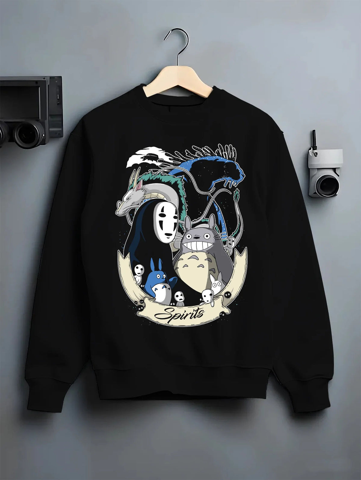 Black crewneck sweatshirt on hanger showing Studio Ghibli: Totoro, No-Face and forest spirits
