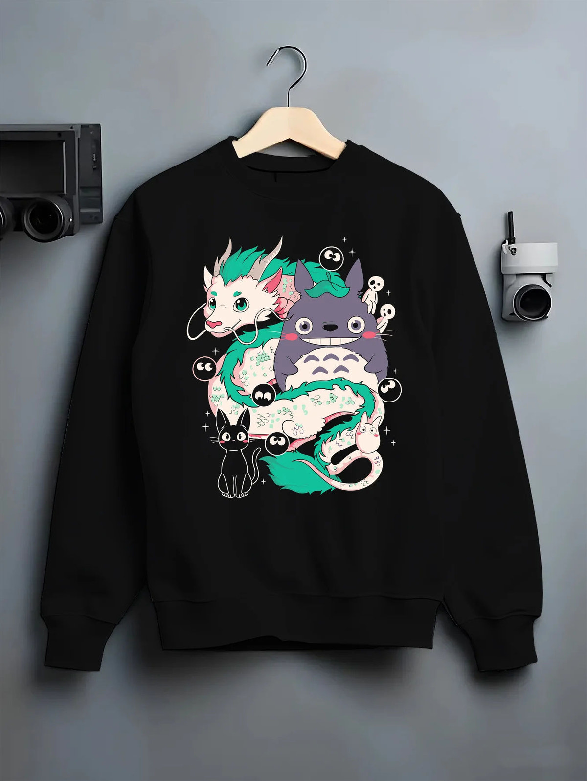 Black crewneck sweatshirt on hanger showing Studio Ghibli crossover: Haku, Totoro and spirits
