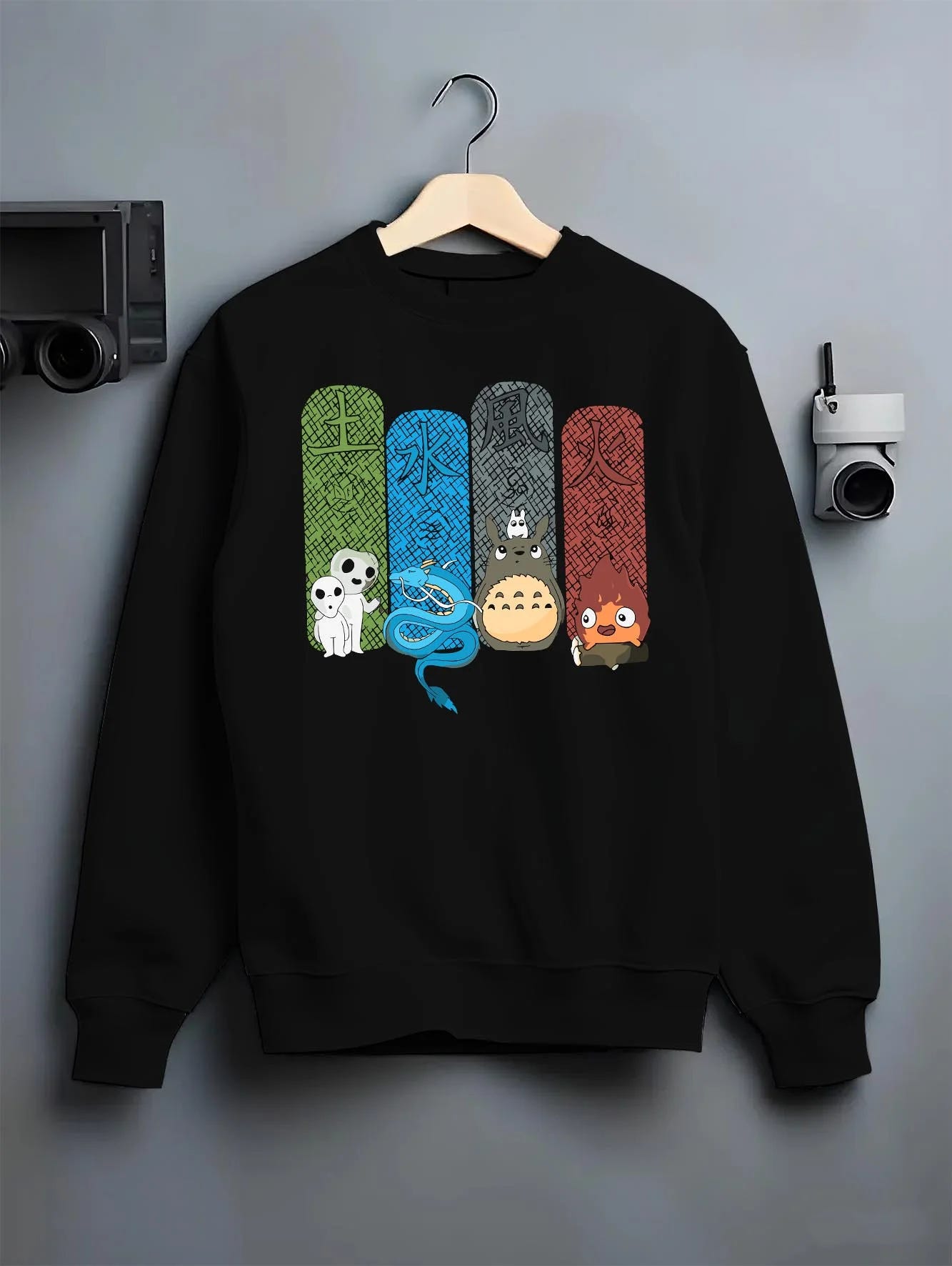 Black crewneck sweatshirt on hanger with Studio Ghibli Hoodie Totoro Spirited Forest Jumper graphic streetwear graphic.