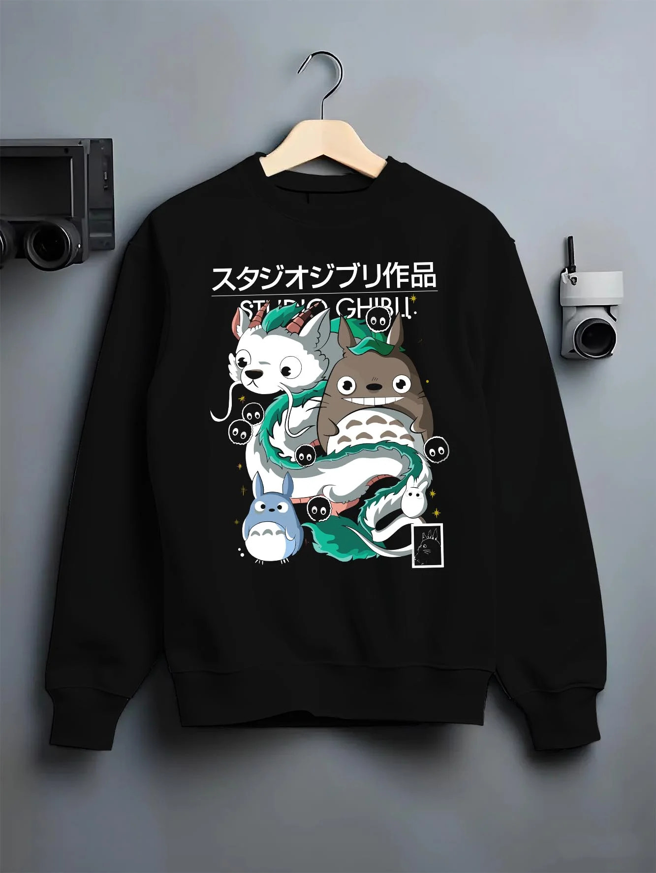 Black crewneck sweatshirt on hanger with Studio Ghibli Hoodie Totoro Blue White Jumper graphic premium wear.