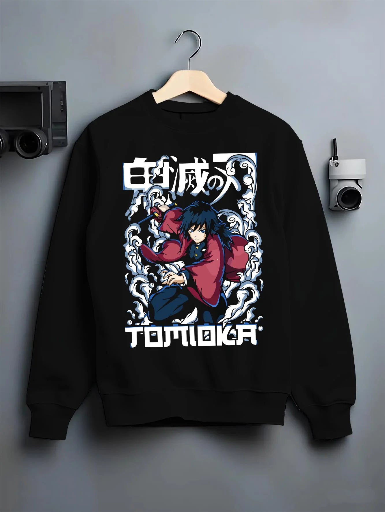 Black crewneck sweatshirt on hanger with Demon Slayer Hoodie Giyu Tomioka Dynamic Pose Jumper graphic streetwear graphic.