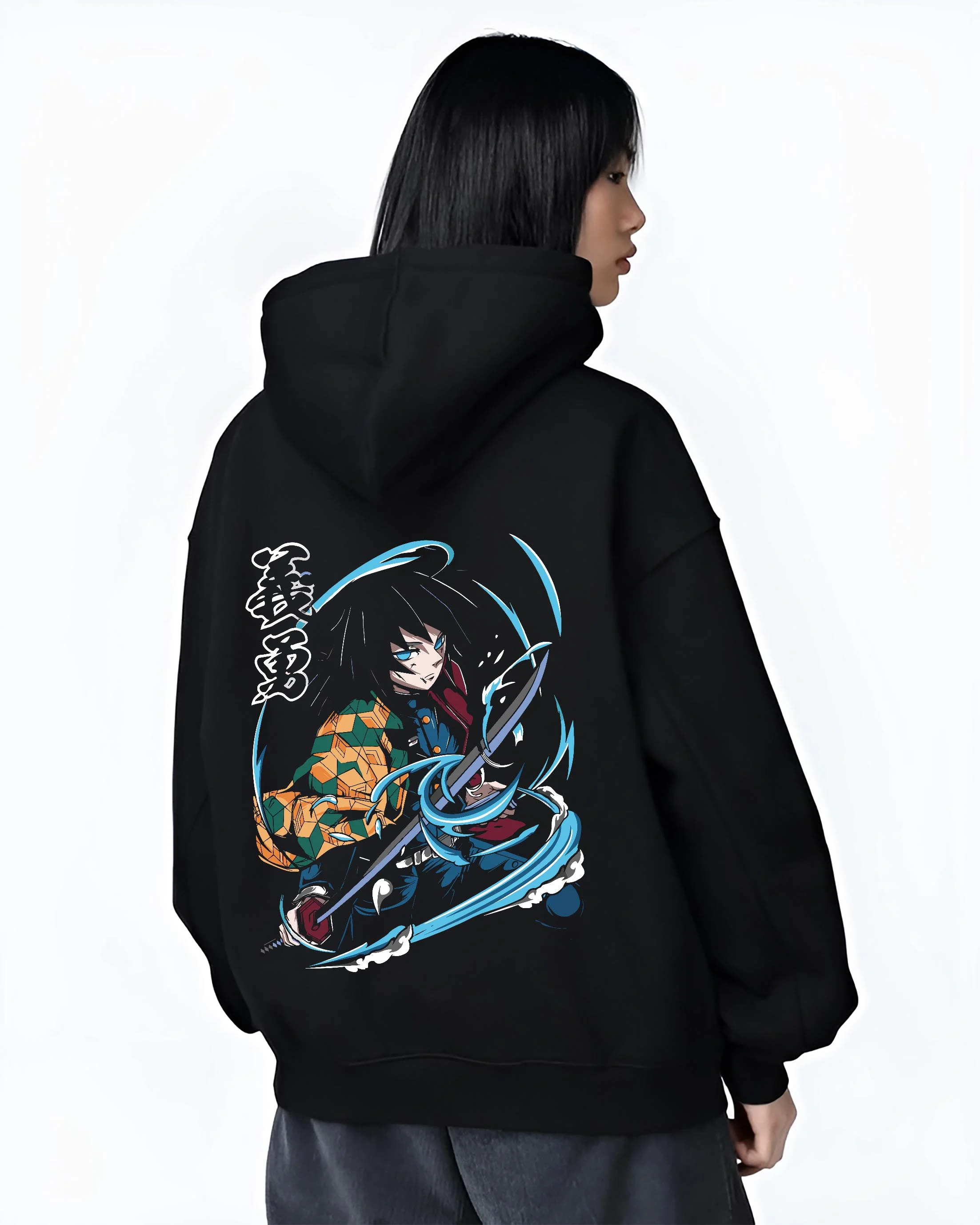 Black hoodie worn by female model, back view with Demon Slayer Hoodie Giyu Tomioka Sword Slash Jumper graphic bold anime graphic.
