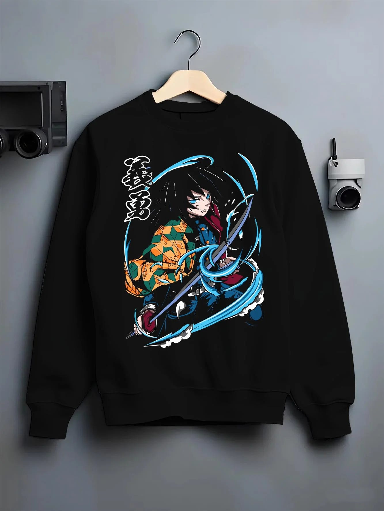Black crewneck sweatshirt on hanger with Demon Slayer Hoodie Giyu Tomioka Sword Slash Jumper graphic bold anime graphic.