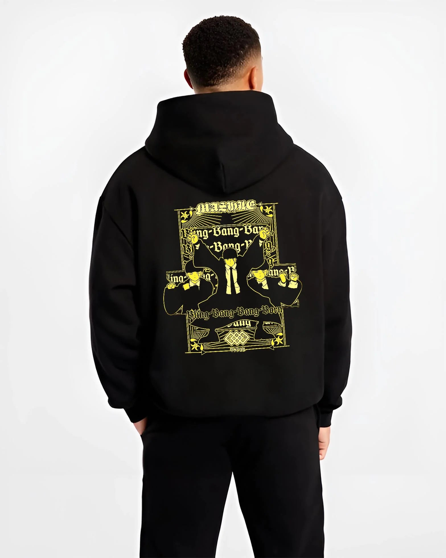 Black hoodie worn by male model, back view highlighting Mash Burnedead Mashle anime motif, retro manga graphic style with Japanese animation streetwear look.