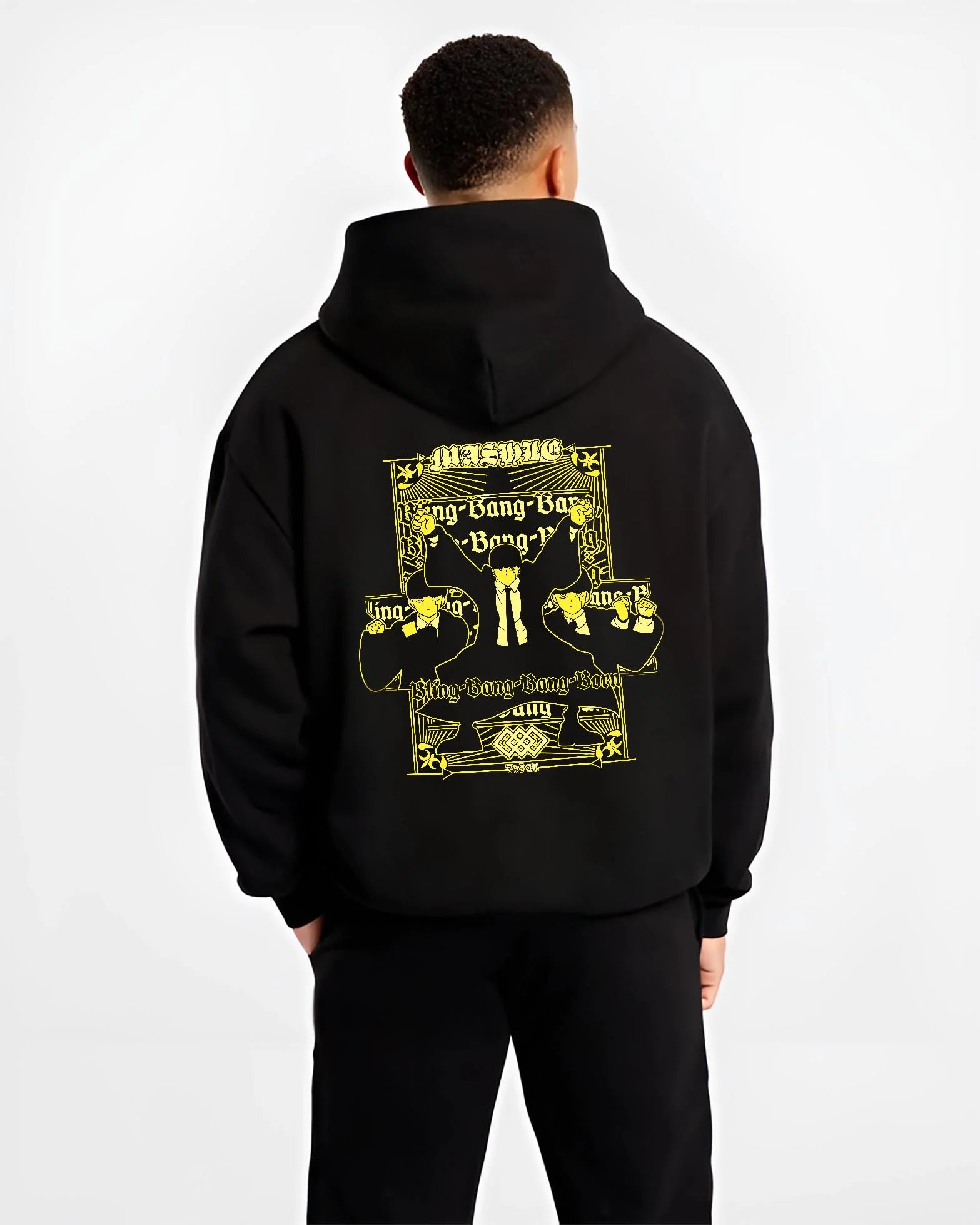 Black hoodie worn by male model, back view highlighting Mash Burnedead Mashle anime motif, retro manga graphic style with Japanese animation streetwear look.