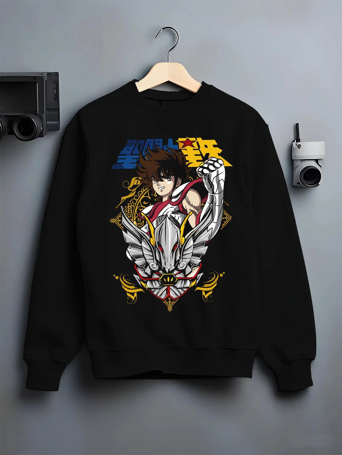 Black crewneck sweatshirt on hanger featuring Pegasus Seiya Saint Seiya gold wings artwork.