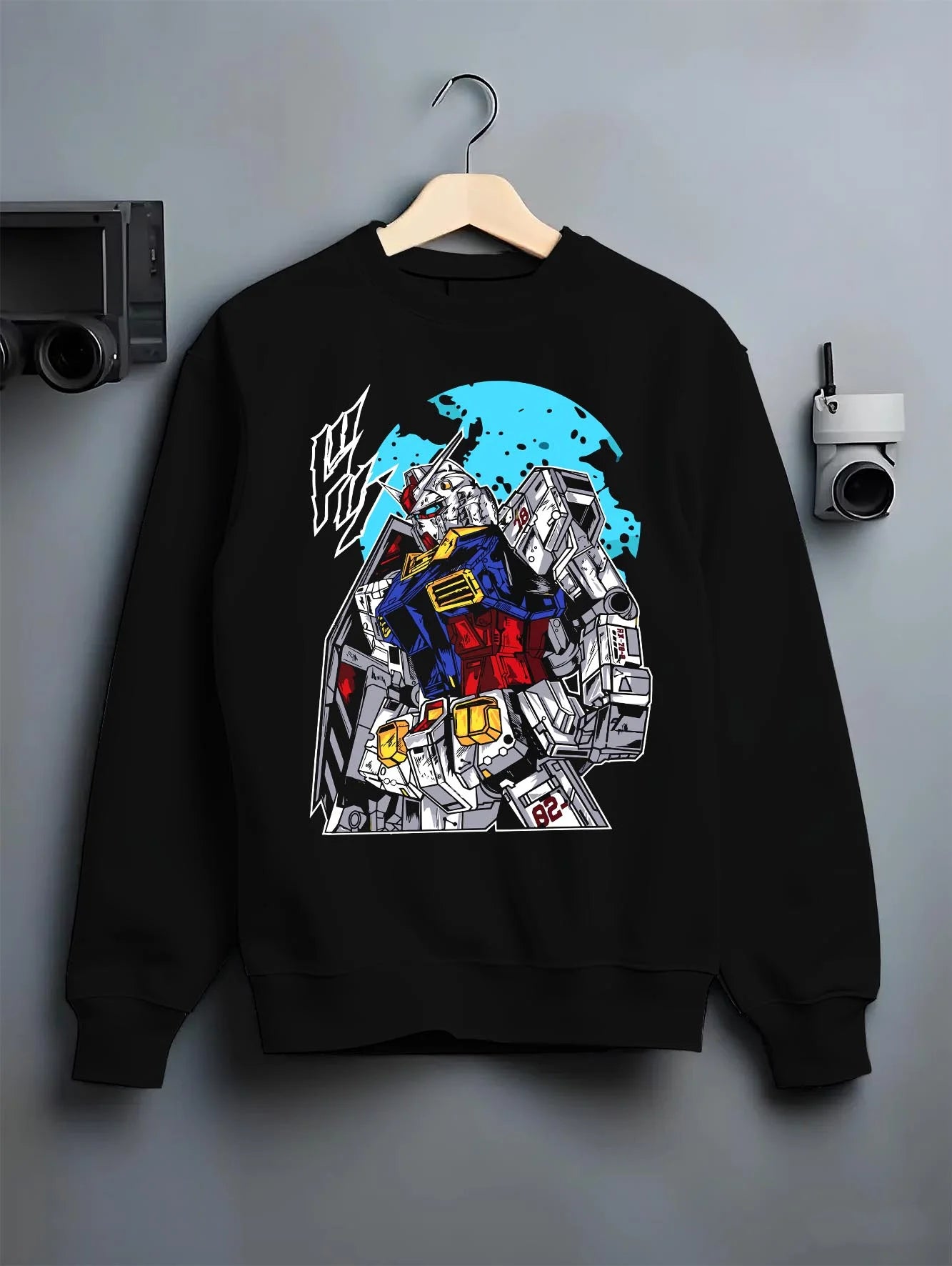 Black crewneck sweatshirt on hanger with Gundam Hoodie RX-78 Battle Suit Heroic Jumper graphic premium wear.