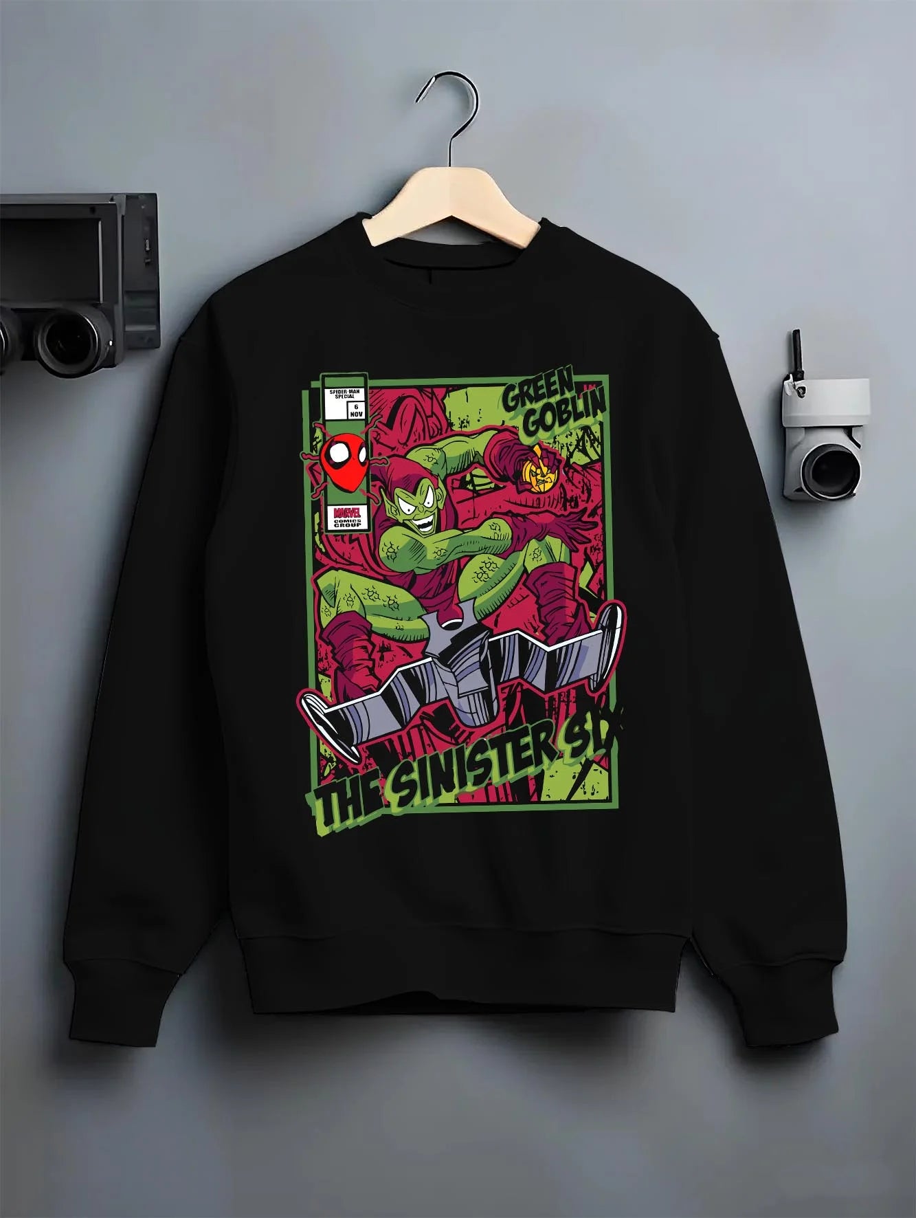 Black crewneck sweatshirt on hanger with Green Goblin Hoodie Marvel Sinister Spider Villain graphic bold anime graphic.
