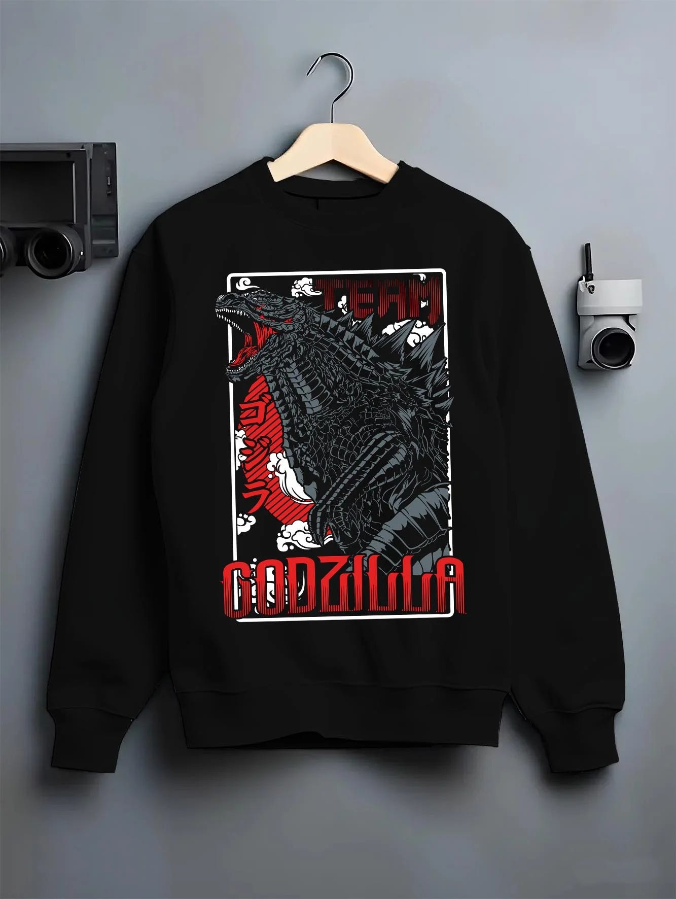 Black crewneck sweatshirt on hanger with Godzilla Hoodie King of Monsters Anime Jumper graphic bold anime graphic.