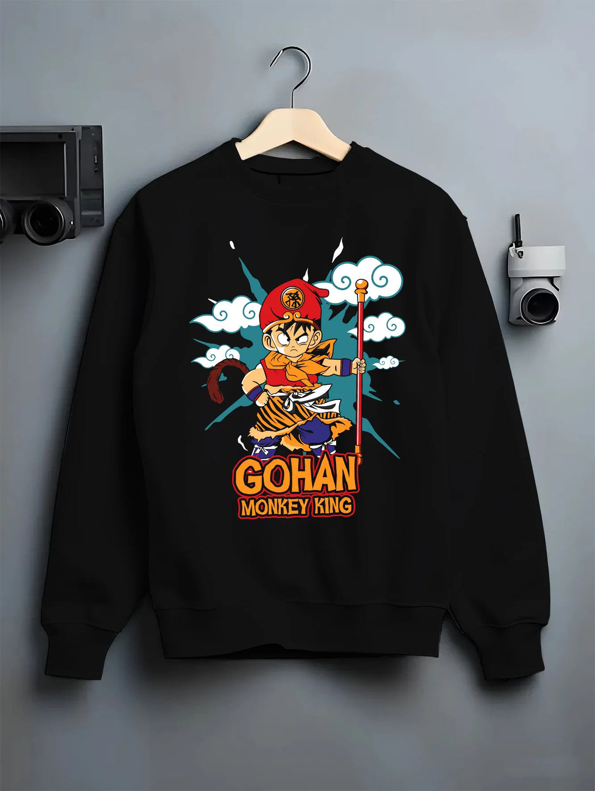 Black crewneck sweatshirt on hanger showing Young Gohan from Dragon Ball: Monkey King staff parody