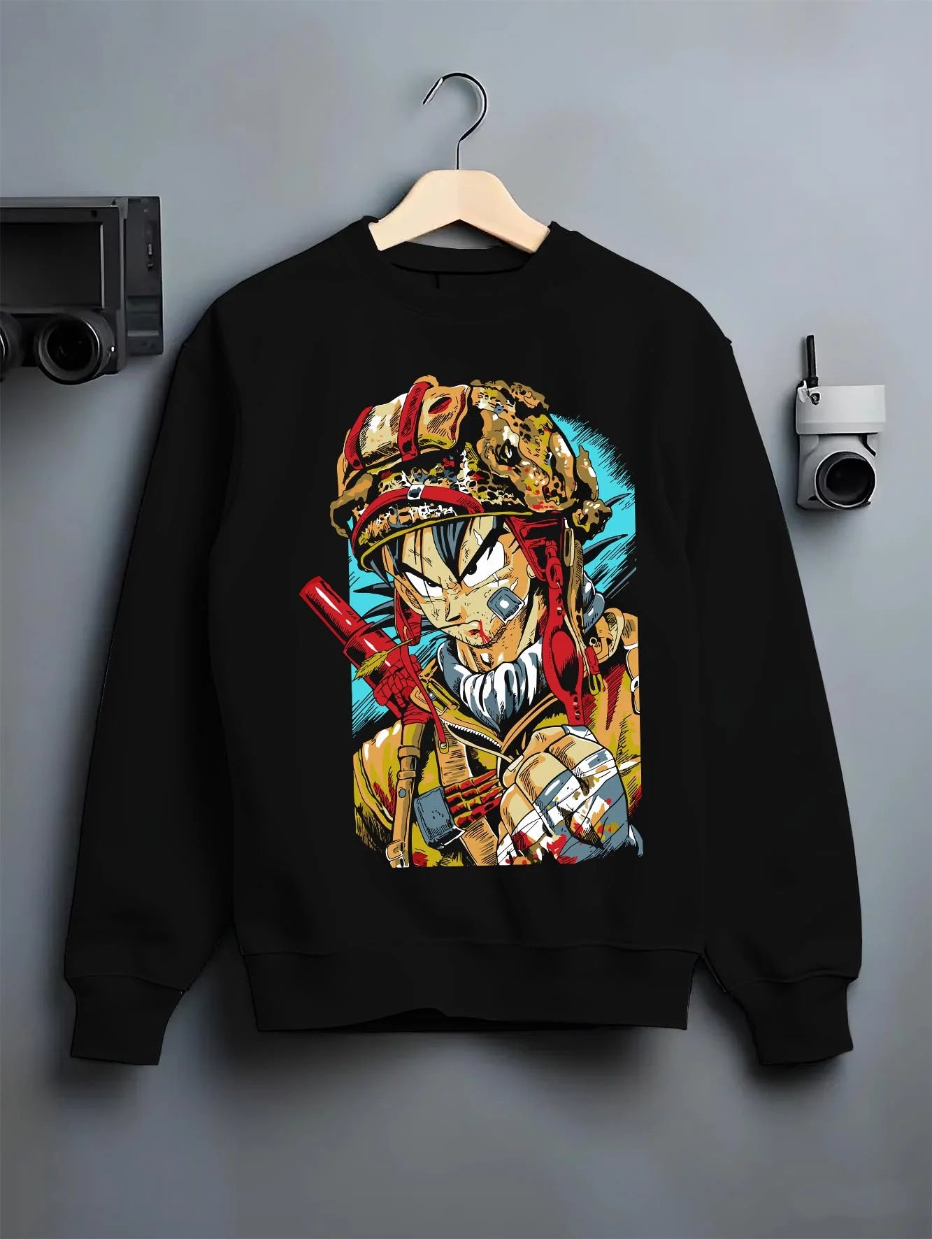 Black crewneck sweatshirt on hanger with Dragon Ball Z Hoodie Goku Army Battle Jumper graphic bold anime graphic.