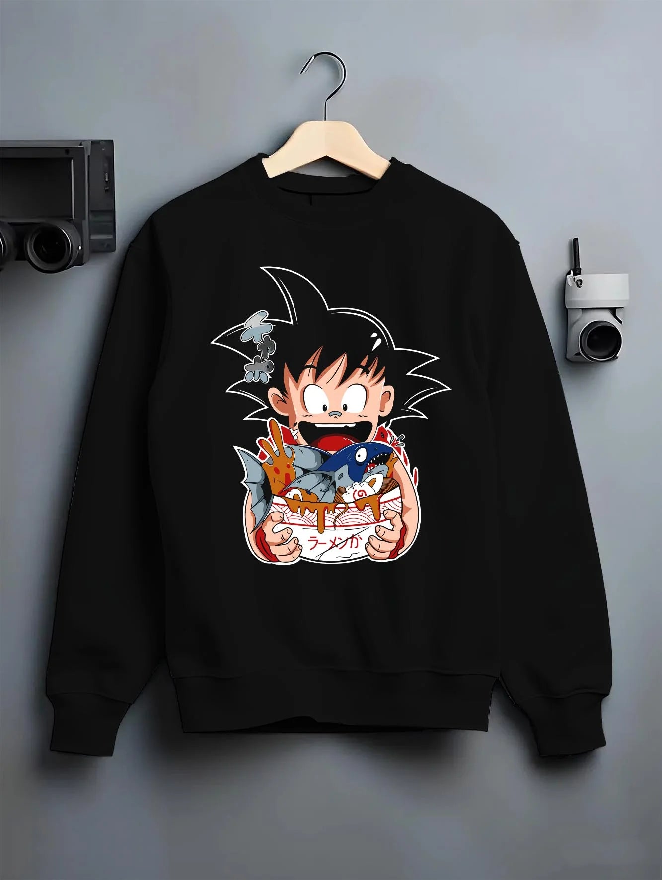 Black crewneck sweatshirt on hanger with Dragon Ball Z Hoodie Kid Goku Classic Jumper graphic premium wear.