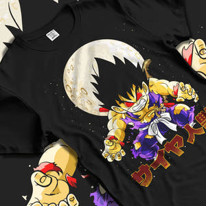 Black T-shirt laid flat with natural folds with Dragon Ball Z Hoodie Kid Goku Oozaru Transformation graphic streetwear graphic.