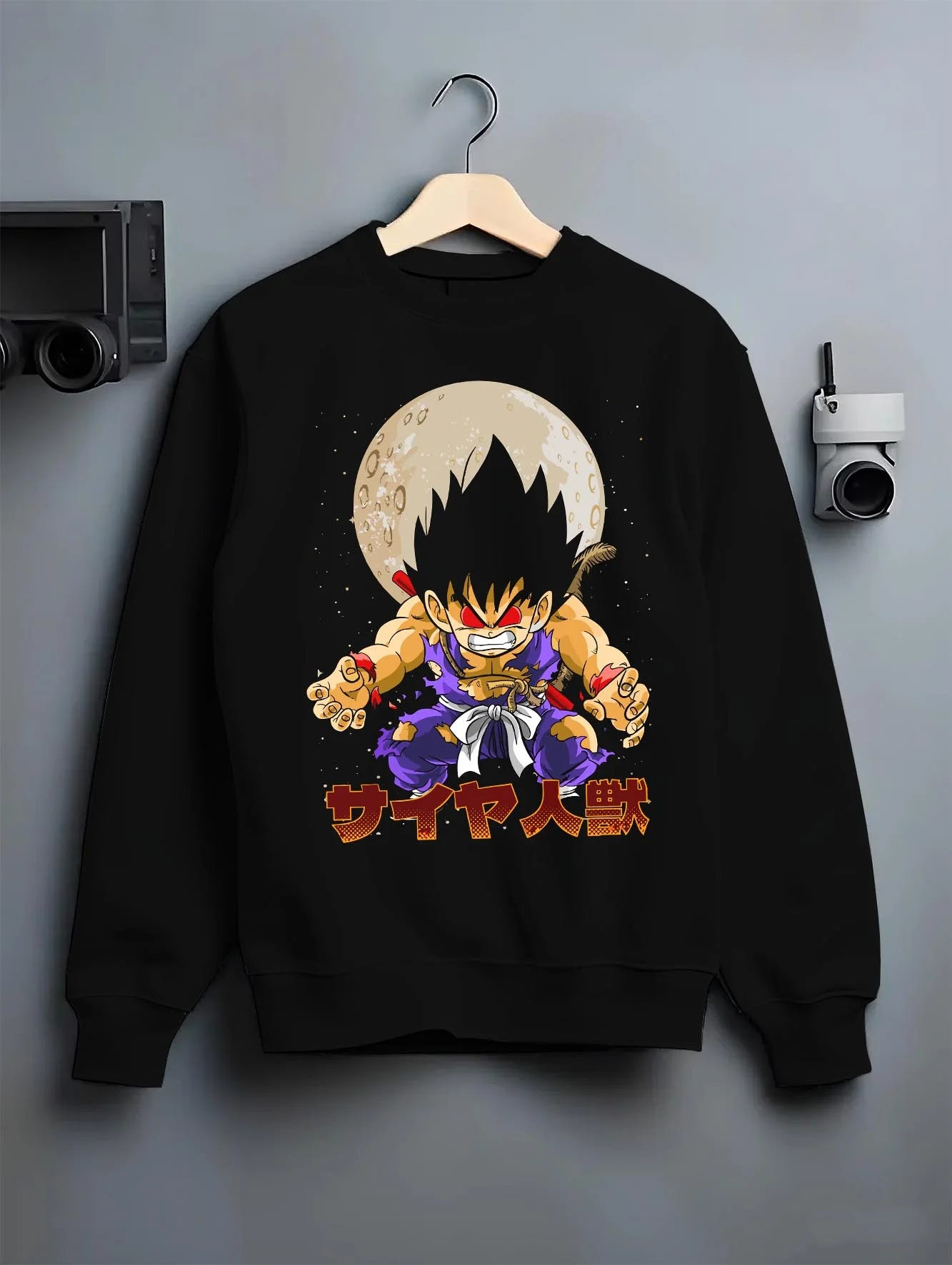 Black crewneck sweatshirt on hanger with Dragon Ball Z Hoodie Kid Goku Oozaru Transformation graphic streetwear graphic.