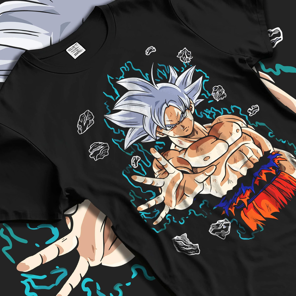 Black T-shirt laid flat with natural folds featuring Goku Ultra Instinct silver aura artwork.