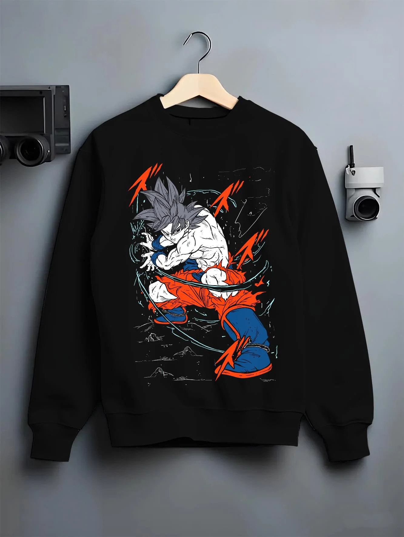 Black crewneck sweatshirt on hanger with Dragon Ball Z Hoodie Goku Ultra Instinct Jumper graphic streetwear graphic.