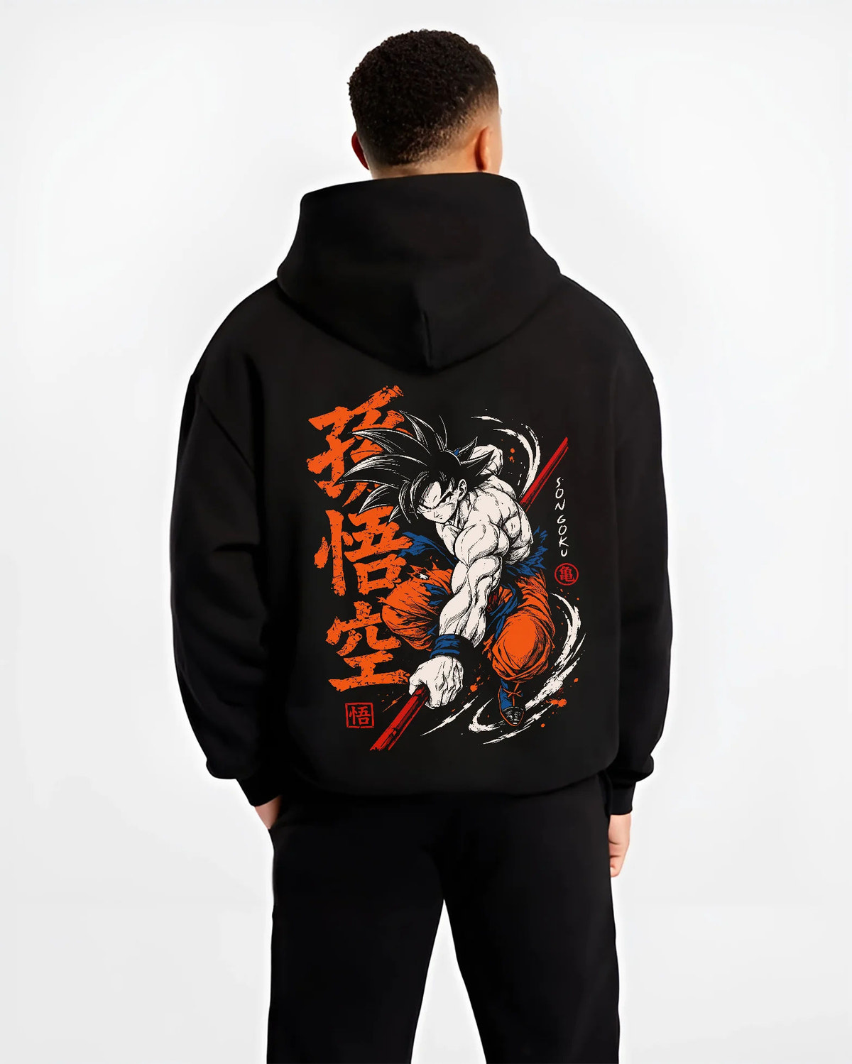 Black hoodie model back view showing Son Goku from Dragon Ball: dynamic martial arts strike