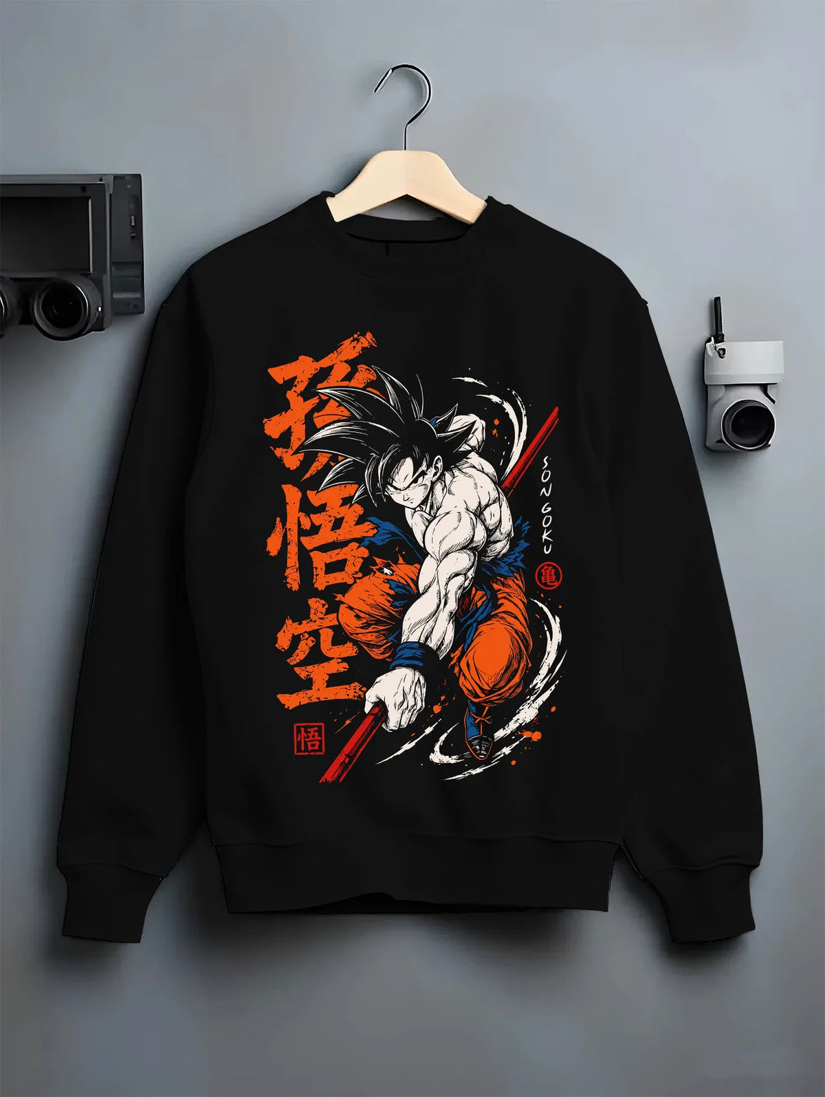 Black crewneck sweatshirt on hanger showing Son Goku from Dragon Ball: dynamic martial arts strike