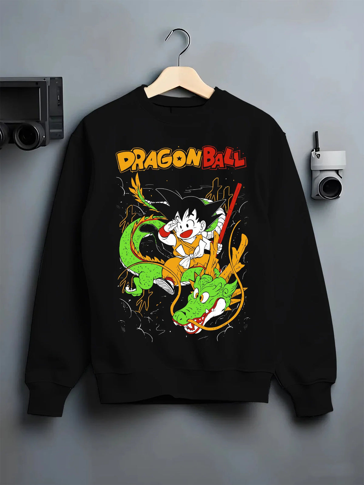 Black crewneck sweatshirt on hanger with Young Son Goku riding Shenron from Dragon Ball illustrated back graphic