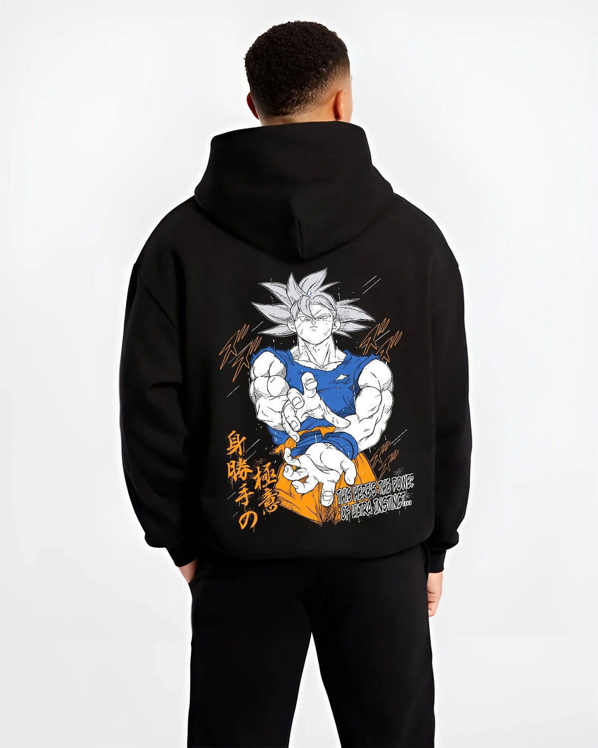 Black hoodie model back view showing Son Goku from Dragon Ball: Ultra Instinct white-haired power pose