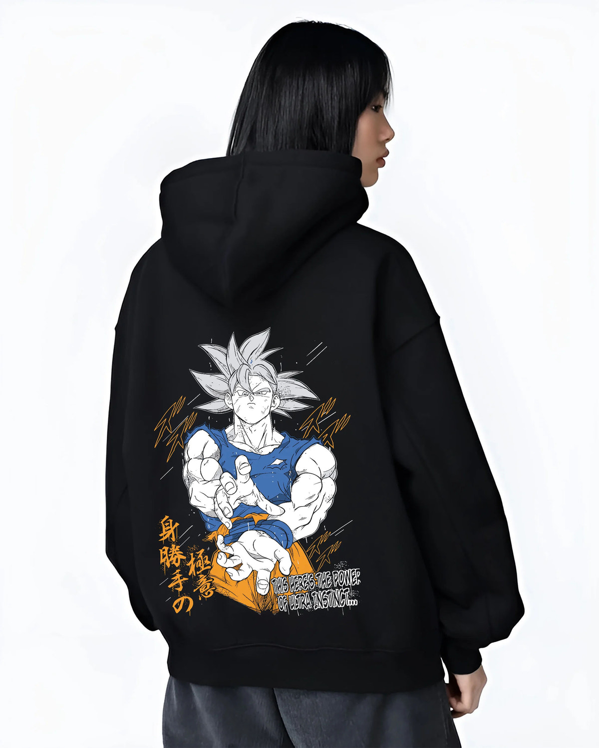 Black hoodie female model back view showing Son Goku from Dragon Ball: Ultra Instinct white-haired power pose