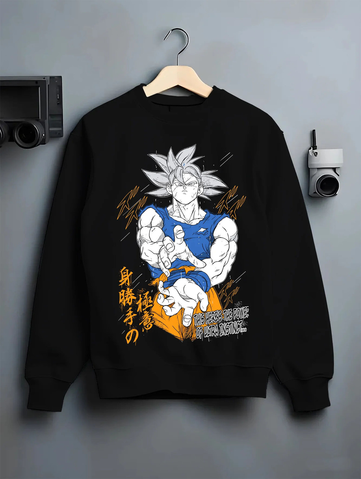 Black crewneck sweatshirt on hanger showing Son Goku from Dragon Ball: Ultra Instinct white-haired power pose
