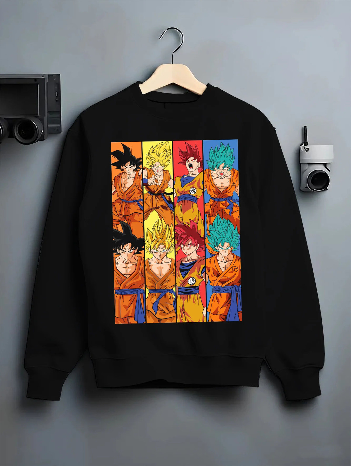 Black crewneck sweatshirt on hanger showing Goku from Dragon Ball: multiple Super Saiyan transformations