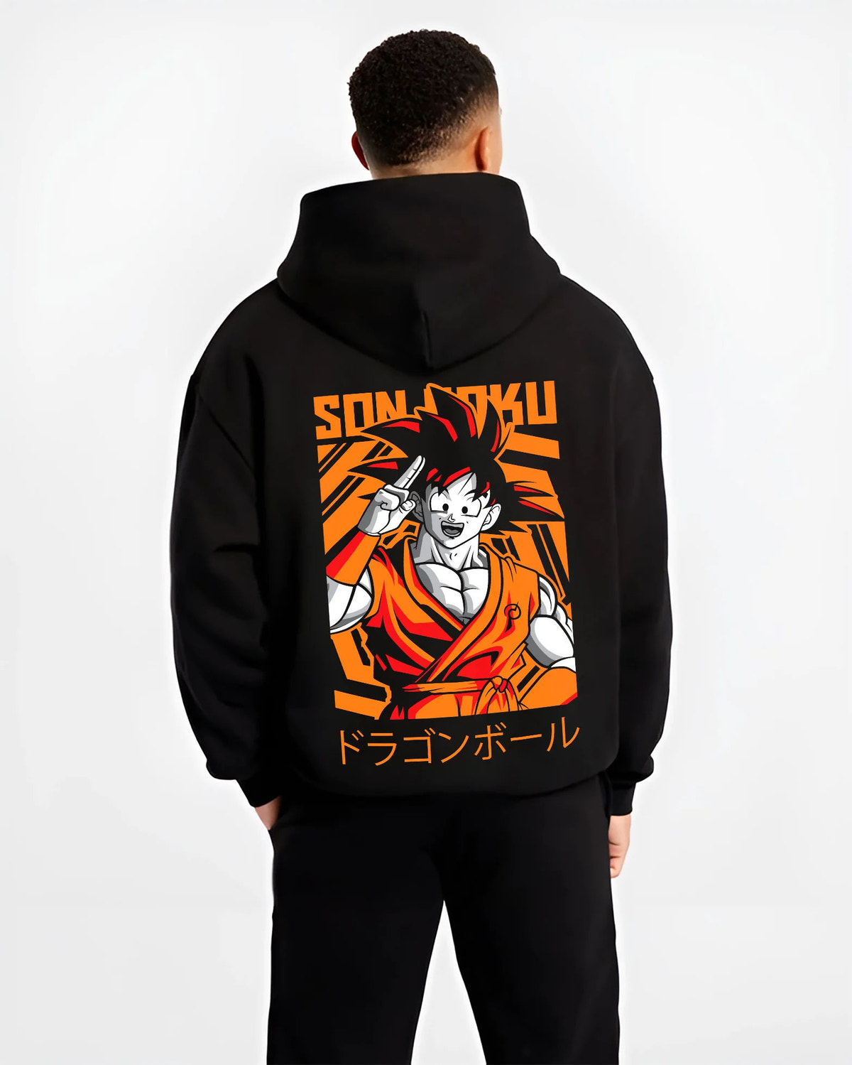 Black hoodie model back view showing Young Goku from Dragon Ball: orange gi and raised hand
